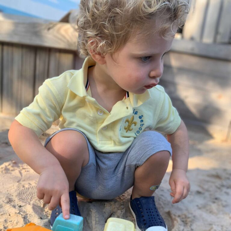 Montessori child playing in sand in Houston TX