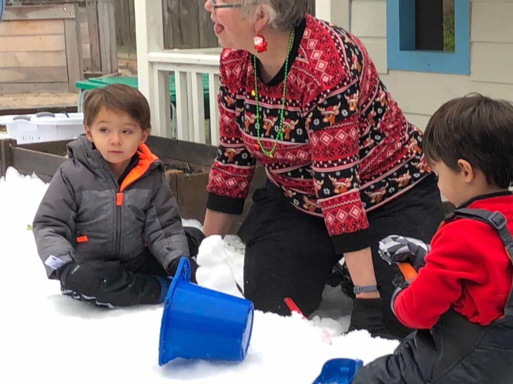 Montessori school students playing in snow in Houston TX